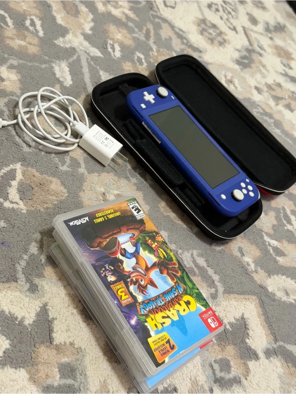 Nintendo Blue Handheld Console with Charger and 4 Game Cards.
